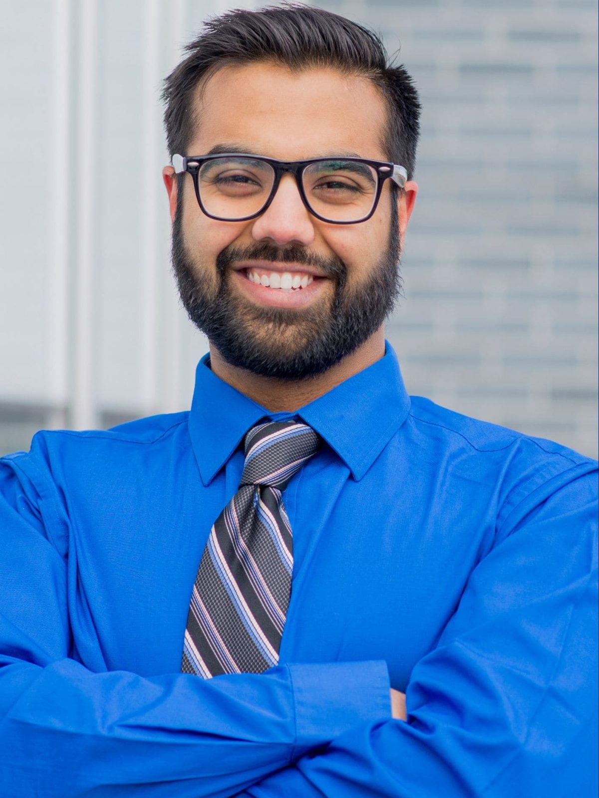a blue shirt man smiling